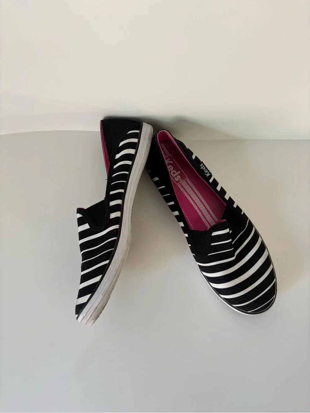 Keds Women’s Black & White Striped Slip-On Sneakers with Pink Insole